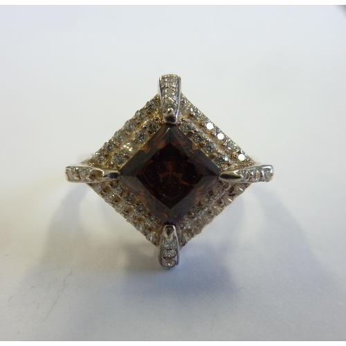 219 - A ladies boxed ring, hallmarked silver and centrally set with a lozenge shaped hand cut stone surrou... 