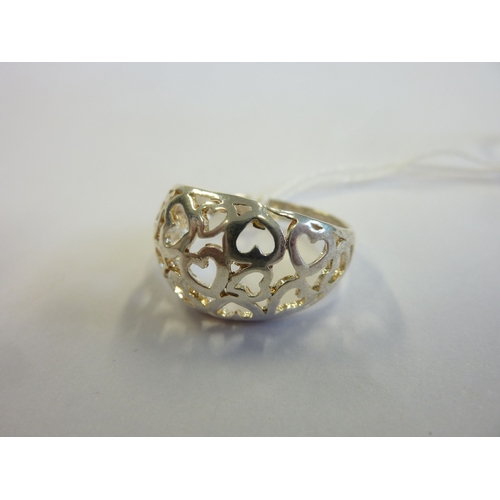 221 - A boxed sterling silver ring pierced with heart designs and motifs etc.,