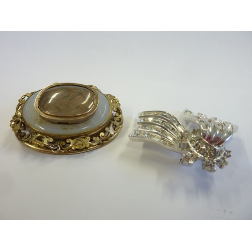 223 - An ornate Victorian mourning brooch together with a costume brooch marked Boucher (boxed)