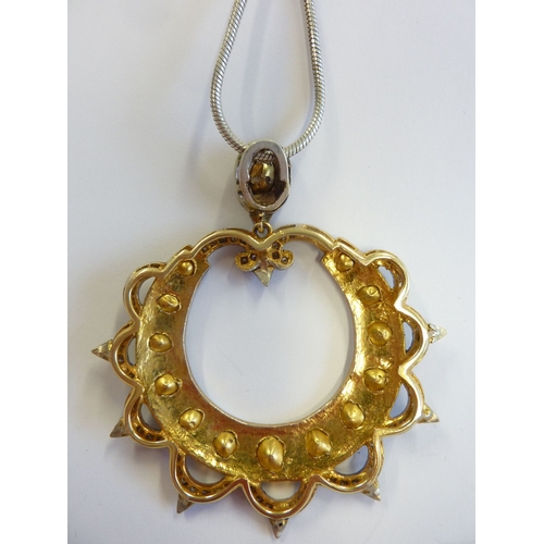 230 - A large and unusual pendant set with large uncut diamonds, on a silver chain