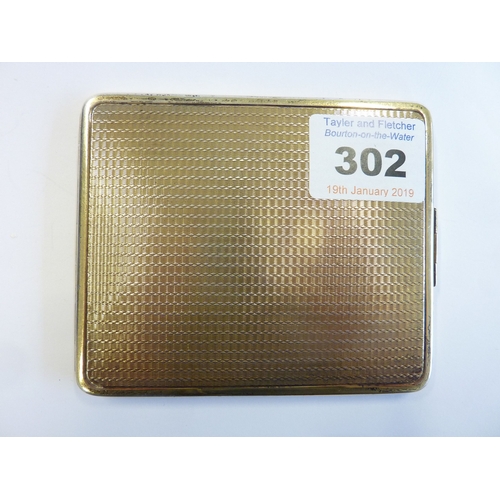 302 - A hallmarked Art Deco style heavy cigarette case (some wear), flip-over clasp and engine turning