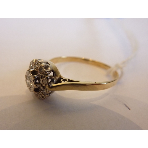 245 - A ladies yellow metal (hallmarked rubbed probably 18 carat gold) flower head style diamond cluster r... 