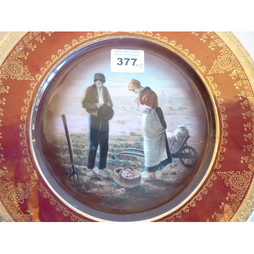 377 - A pair of early-20th century Viennese porcelain plates; hand-gilded borders and decorated with harve... 