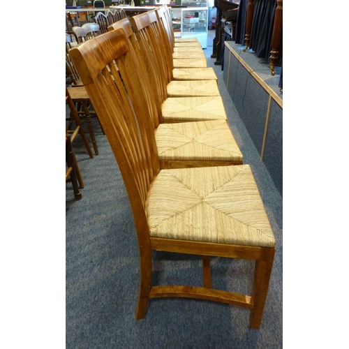 461 - A good and long set of ten stained hardwood and rush seated dining chairs having angular slatted bac... 