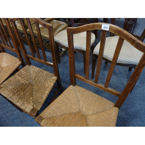 464 - A set of four 19th century elm vernacular chair, each having rush seat and turned front legs united ... 