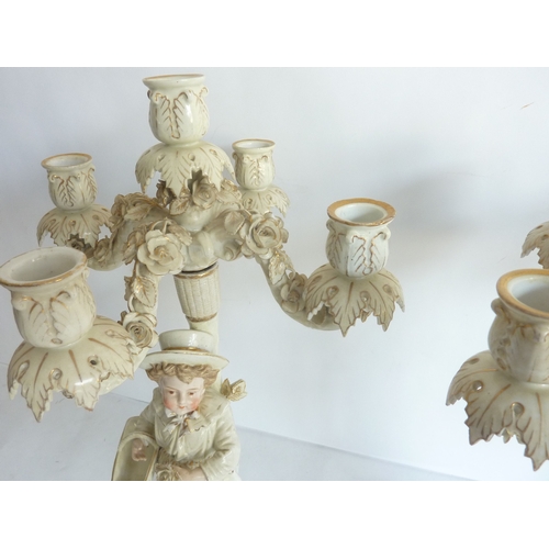 25 - A pair of 19th century Meissen-style hand-decorated figural five-light porcelain table candelabra (d... 