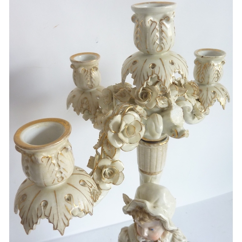 25 - A pair of 19th century Meissen-style hand-decorated figural five-light porcelain table candelabra (d... 