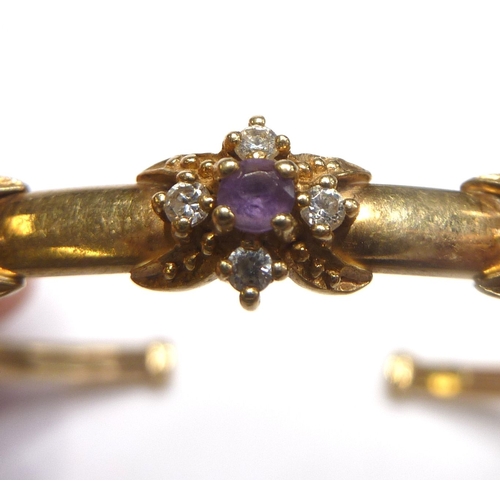 100 - A 9-carat gold bangle set with amethyst and white sapphire clusters