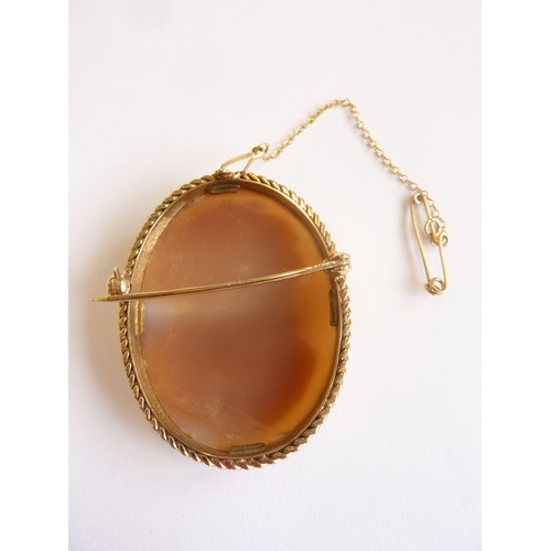 110 - A 9-carat gold-framed cameo brooch with safety chain