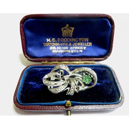 123 - An antique 18-carat gold emerald and diamond bow brooch