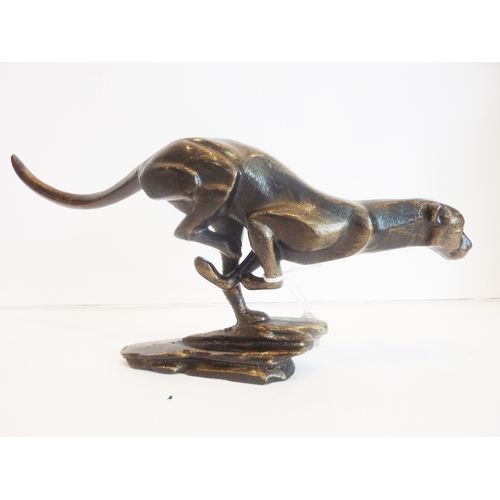 75 - A cast-metal sculpture of a cheetah at full speed