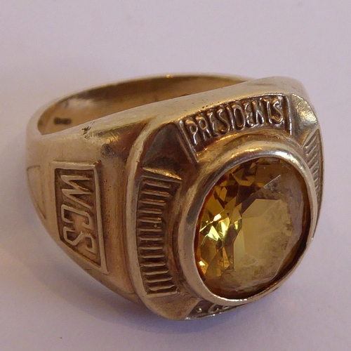 119 - A hallmarked gold ring set with a hand-cut oval stone (possibly a citrine) 'President's Club', also ... 