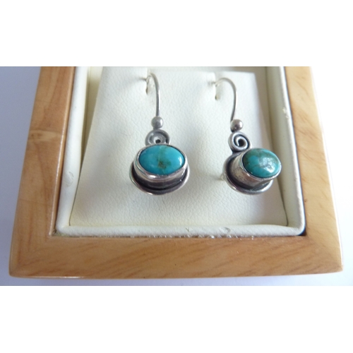 114A - ADDED LOT      A pair of silver wire earrings horizontally set with cabouchon turquoise, within poli... 