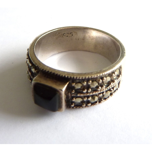 114B - ADDED LOT       A ladies boxed silver ring of heavy gauge, centrally set with a black onyx style har... 