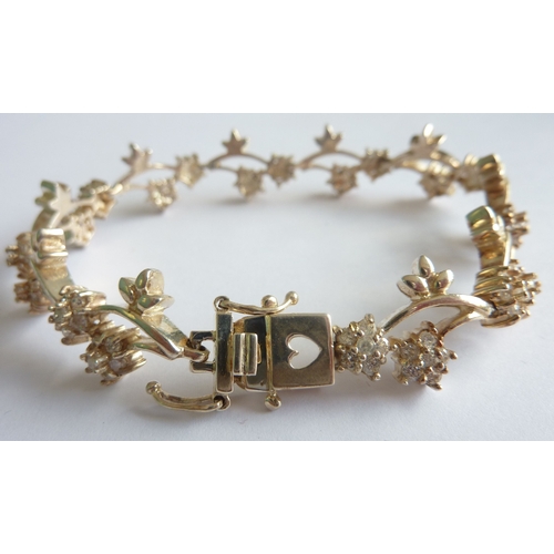 114C - ADDED LOT       A stylish and dainty silver bracelet as a myriad of alternating flower heads, each s... 