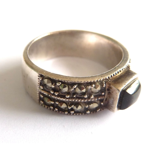 114B - ADDED LOT       A ladies boxed silver ring of heavy gauge, centrally set with a black onyx style har... 