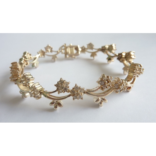 114C - ADDED LOT       A stylish and dainty silver bracelet as a myriad of alternating flower heads, each s... 