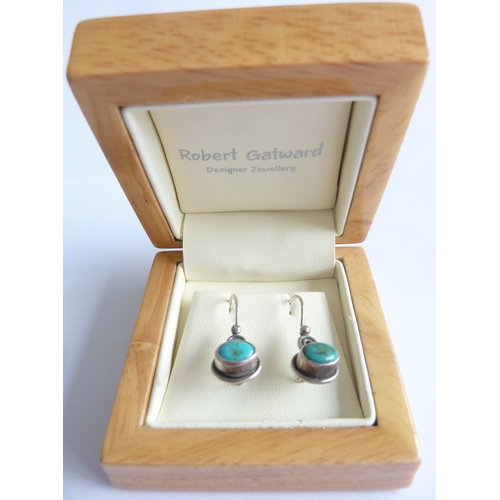 114A - ADDED LOT      A pair of silver wire earrings horizontally set with cabouchon turquoise, within poli... 