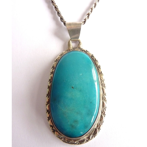 101B - ADDED LOT       A large oval silver pendant mounted with a sky blue Ruskin style hardstone within an... 