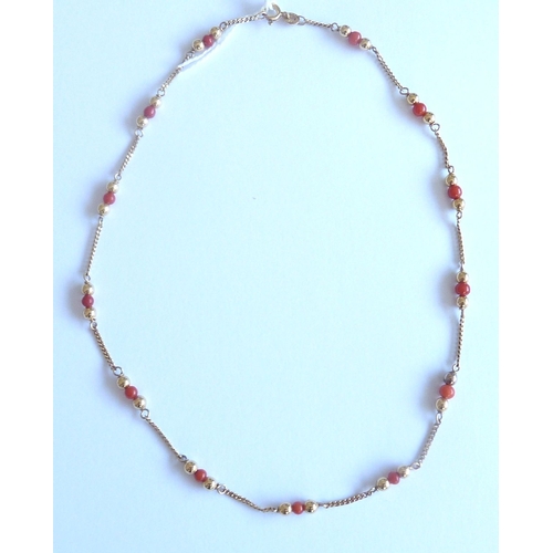 96 - A gold and coral necklace