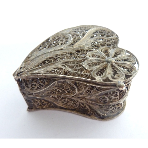 104 - Two Continental white metal boxes, the first a heart-shaped filigree box with hinged cover, the seco... 