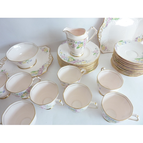 11 - A mid-20th century Tuscan china tea service; comprising nine cups, saucers, side plates, cake plates... 