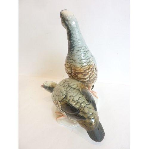 17 - A pair of hand-decorated porcelain partridges