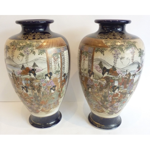 27 - A pair of large Satsuma blue ground vases with panels of figures and Mount Fuji, three-character mar... 