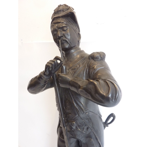 67 - A large 19th century style (reproduction) bronze model of a soldier lighting his pipe; signed to bot... 