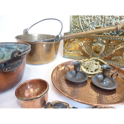 74 - An interesting selection of copper and brassware to include a trivet, brass stands, martingales and ... 