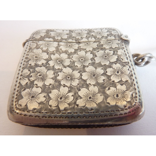 84 - A hallmarked silver vesta case with floral engraving