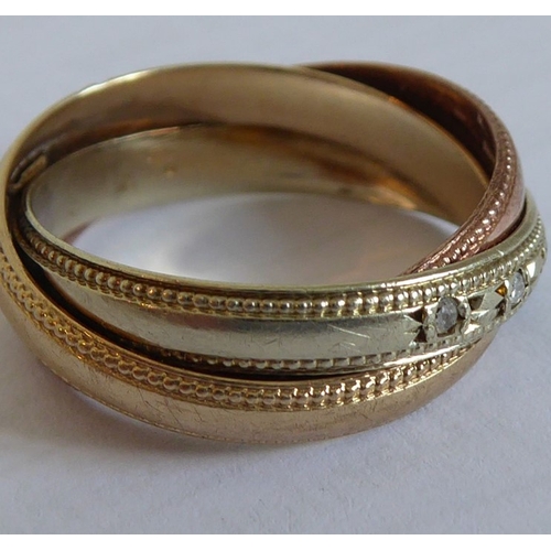183 - A 9-carat gold Russian style wedding ring set with diamonds (The cost of UK postage via Royal Mail S... 