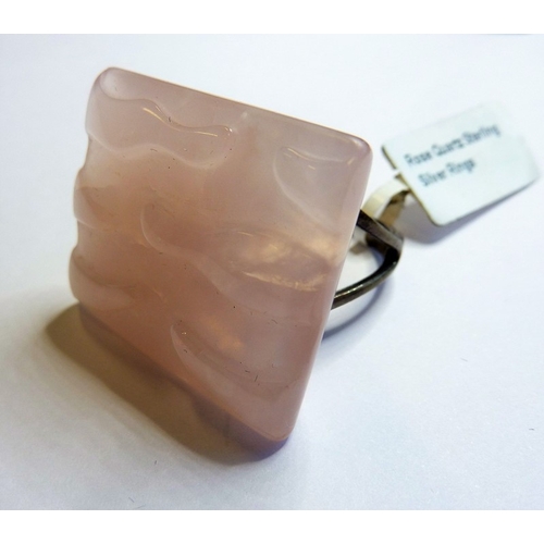 196 - A modern designer sterling silver ring mounted with a textured rectangular rose-quartz stone (origin... 