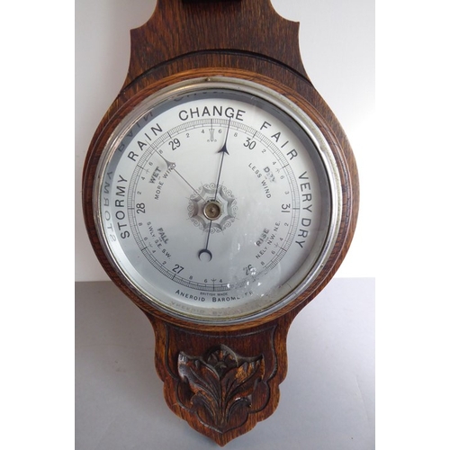 217 - An early 20th century oak-cased wall-hanging aneroid barometer