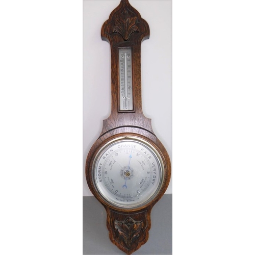 217 - An early 20th century oak-cased wall-hanging aneroid barometer