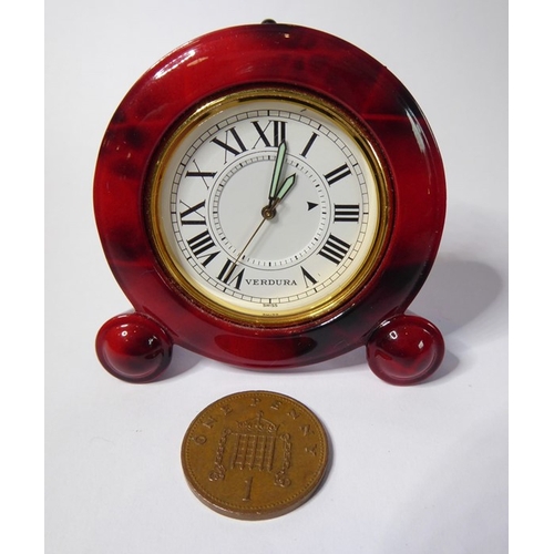 222 - A Verdura miniature travel clock; red-and-brown faux-marble case surrounding a gold insert and white... 