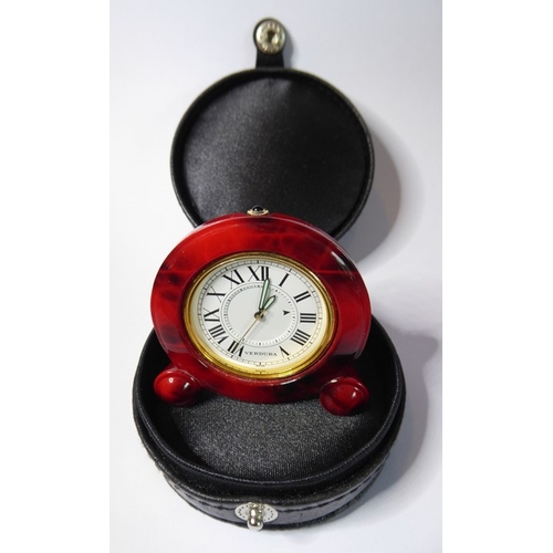 222 - A Verdura miniature travel clock; red-and-brown faux-marble case surrounding a gold insert and white... 