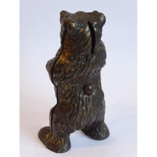 104 - A late 19th century money bank in the form of a standing cast iron bear (traces of original gilding)... 