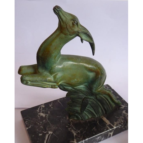 106 - A pair of Art Deco book ends modelled as naturalistic verdigris leaping gazelles, each on black and ... 