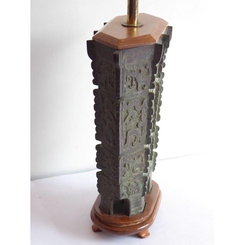 108 - An archaistic-style heavily patinated Chinese bronze wood-mounted table lamp; the height-adjustable ... 