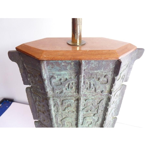 108 - An archaistic-style heavily patinated Chinese bronze wood-mounted table lamp; the height-adjustable ... 