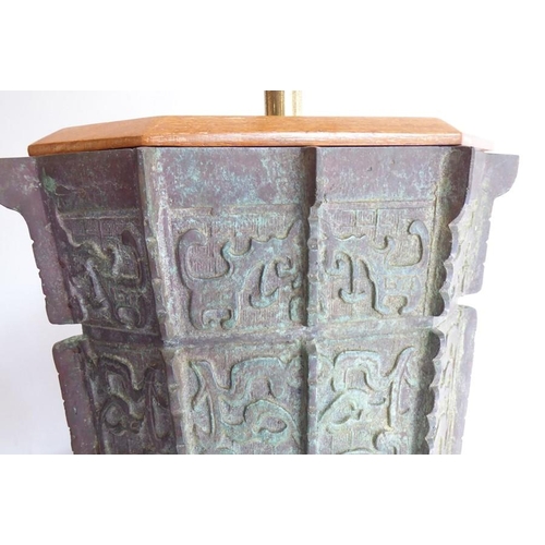 108 - An archaistic-style heavily patinated Chinese bronze wood-mounted table lamp; the height-adjustable ... 