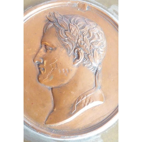 109 - An early 19th century Grand Tour copper relief of Napoleon (as Caesar); the head in profile and agai... 