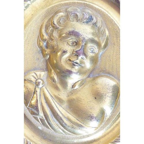 110 - A 19th century circular gilt-metal wall-hanging relief study of a young male figure with curly hair ... 