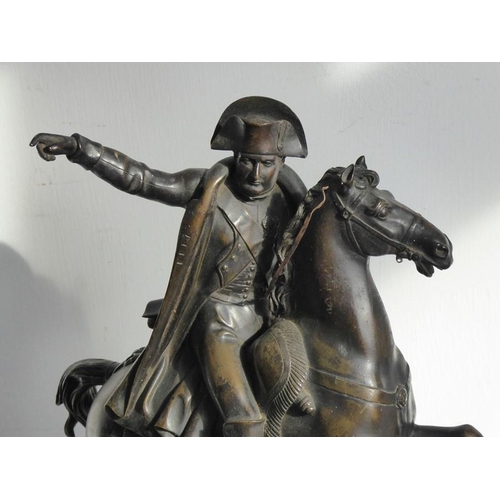 111 - An early/mid-19th century patinated bronze sculpture of Napoleon on horseback; mounted upon a rectan... 