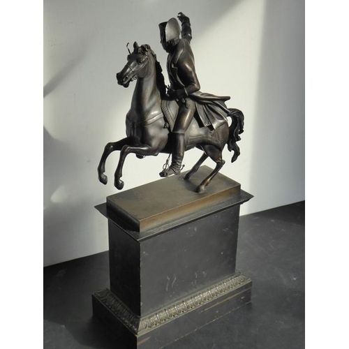 111 - An early/mid-19th century patinated bronze sculpture of Napoleon on horseback; mounted upon a rectan... 