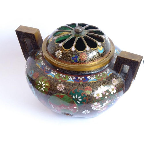 114 - A Japanese Meiji period two-handled cloisonné koro; the pierced dome topped cover flanked by two ang... 