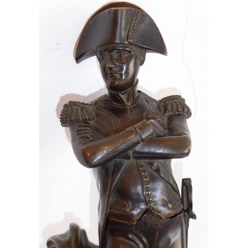 125 - A late 19th/early 20th century patinated bronze sculpture of Napoleon; with arms crossed, his sword ... 