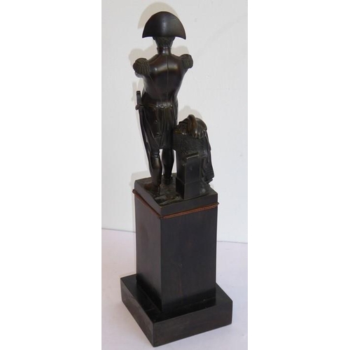 125 - A late 19th/early 20th century patinated bronze sculpture of Napoleon; with arms crossed, his sword ... 