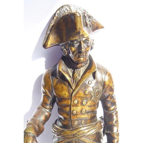 126 - A 19th century patinated bronze of a soldier in bicorn hat; in his left hand he holds a scroll and i... 